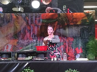 Poppy Tooker performing a cooking demonstration at Jazz Fest.  